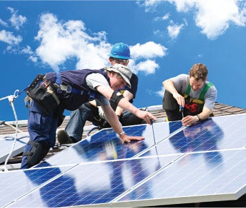 workers installing a solar panel